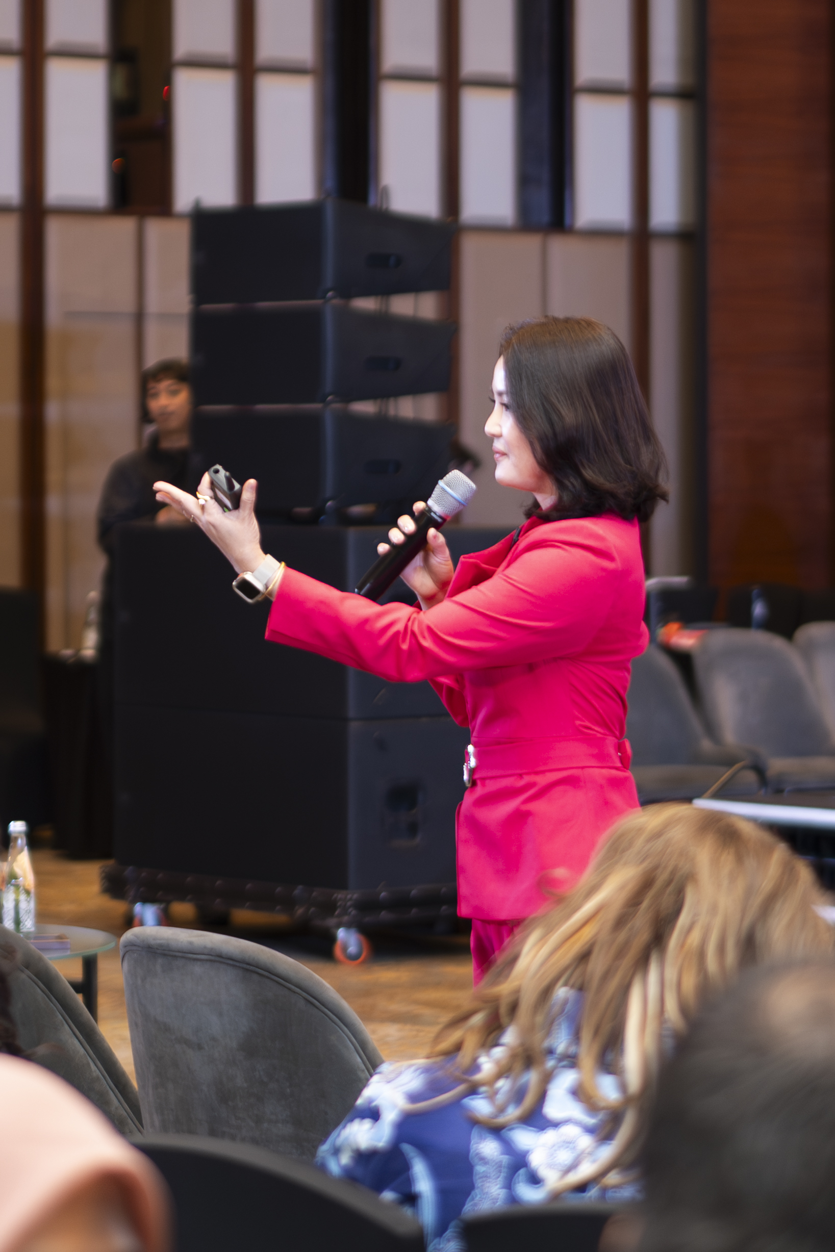 Yulia Saksen speaking among an audience